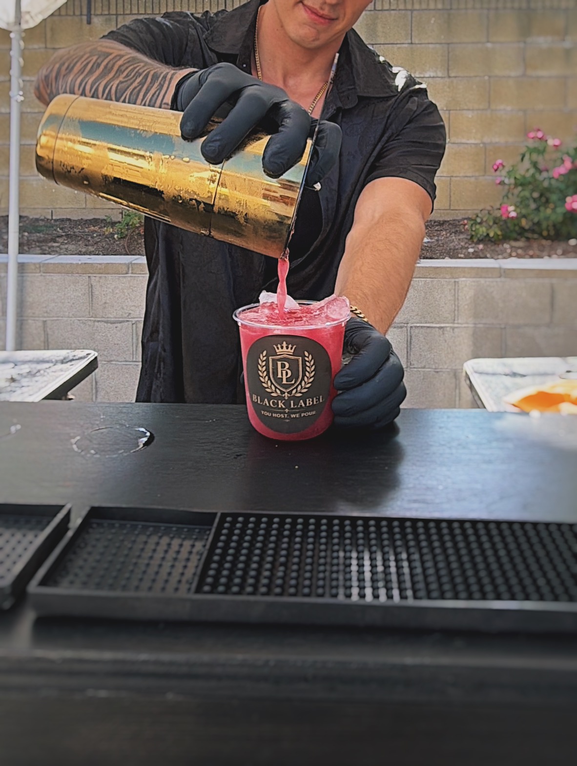 Professional bartender pouring a cocktail at a luxury event